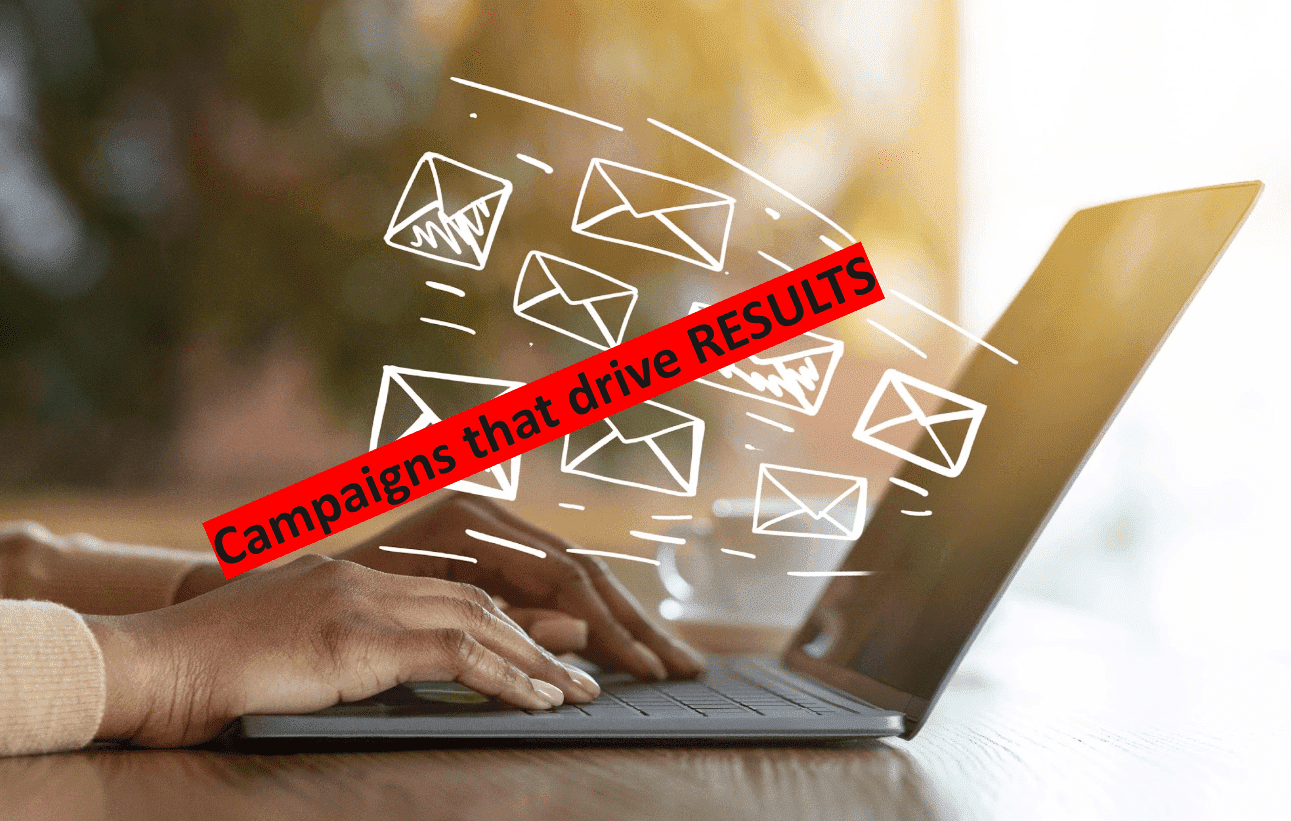 Hand on laptop with emails launching from the screen. Email automation drives results.